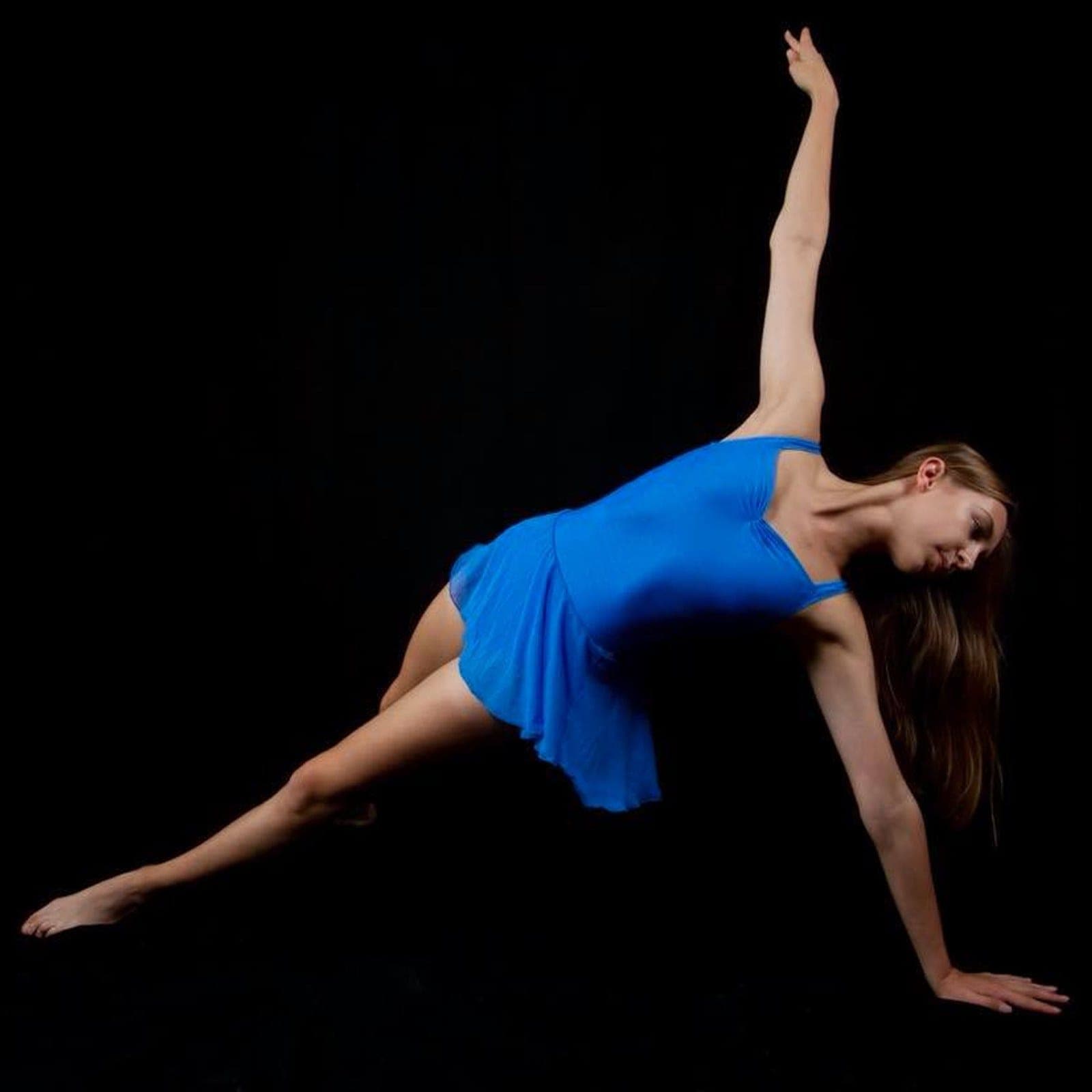 Contemporary dancer in electric blue holding a floor pose in Saltash