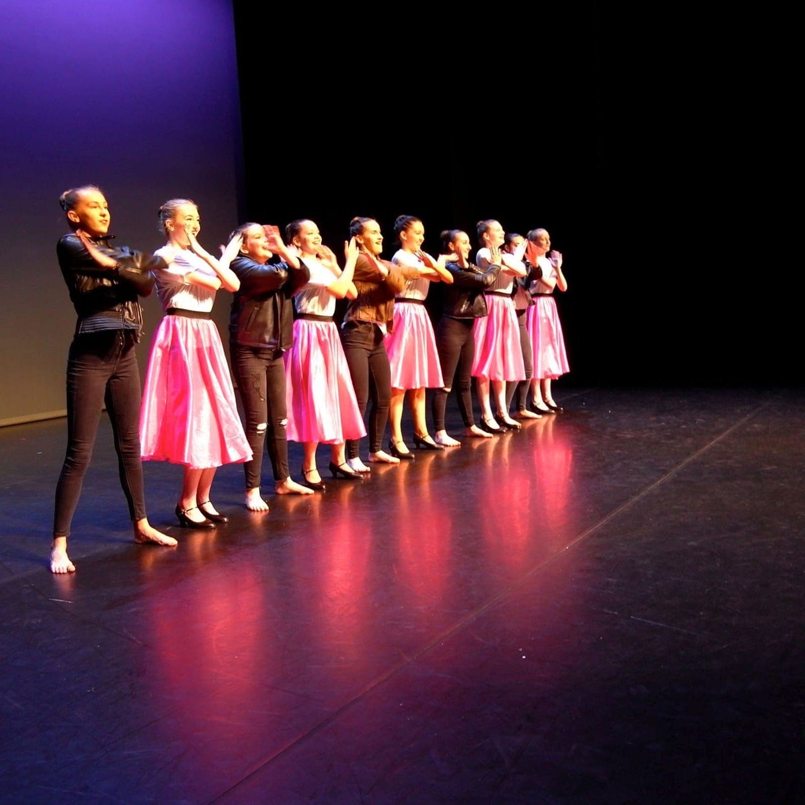 Musical theatre dancers in a high-energy stage number in Saltash and Plymouth