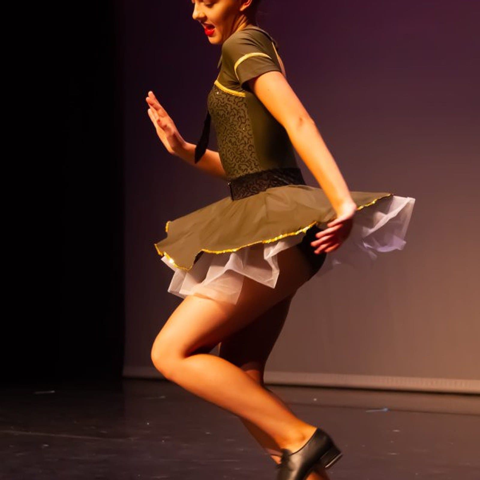 Tap dancer in costume mid-routine at a Geraldine Lamb show in Plymouth